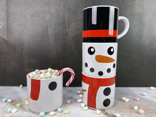 Stapelbara muggar med en snögubbe