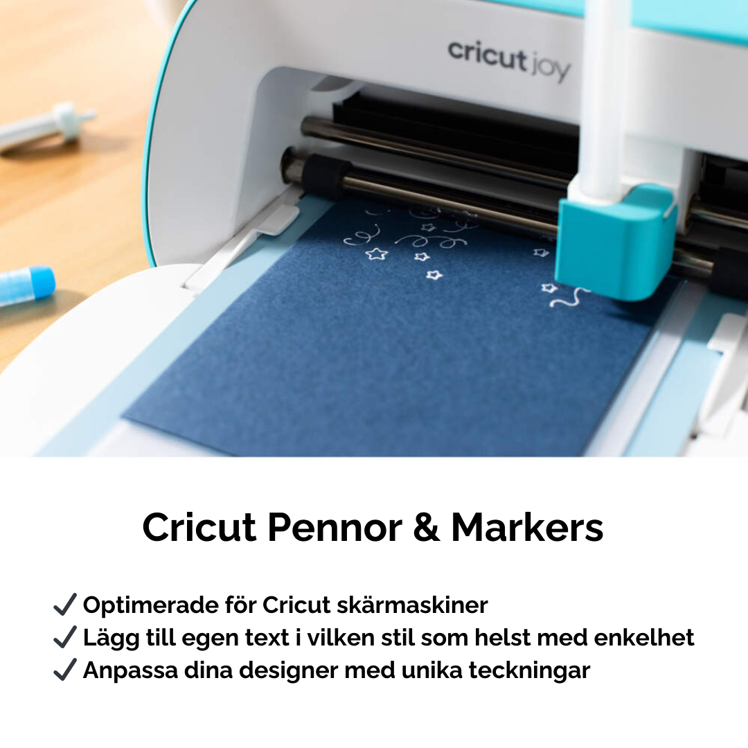 Cricut Joy Opaque Acrylic Pens i vitt bläck används för att rita stjärnor och detaljer på mörkt papper.